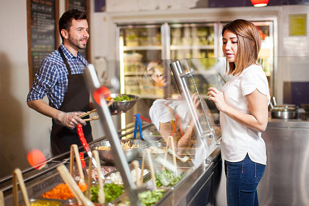istock Cute girl making her own salad at a restaurant 510071034