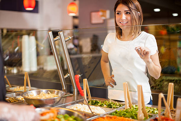 istock Cute girl choosing her salad at a restaurant 510071422