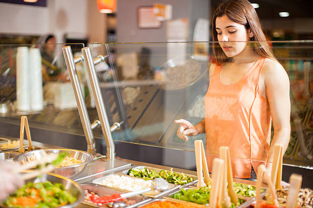 Pointing at her favorite ingredients for a salad