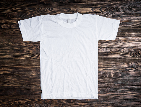 white cotton t-shirt on wooden background