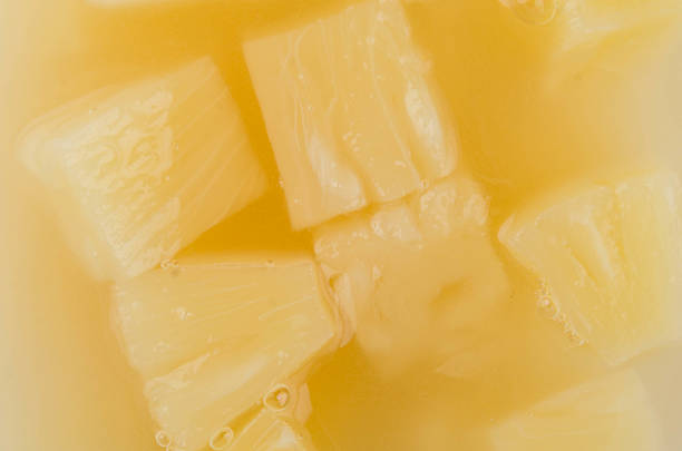 Delicious sweet pieces of ananas pineapple in a healthy fruit juice. Photo made with high quality photo equipment in a modern photo studio.