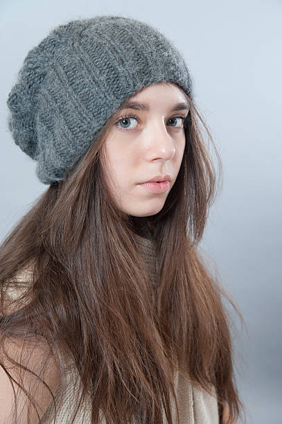 istock Young brunette girl in a knitted hat. 510074946