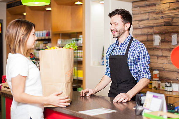 istock Handsome cashier helping out a customer 510076462