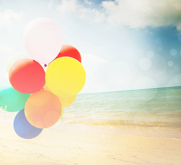 istock Colorful balloons on the beach 510076760