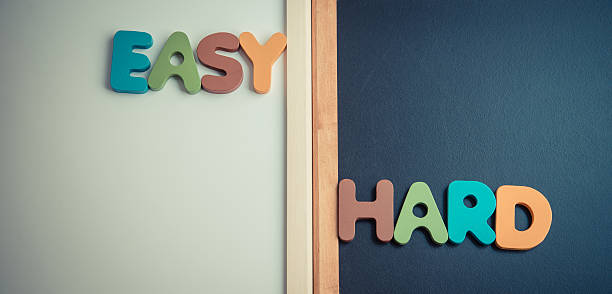 istock Wooden word EASY and HARD on black and white board 510076980