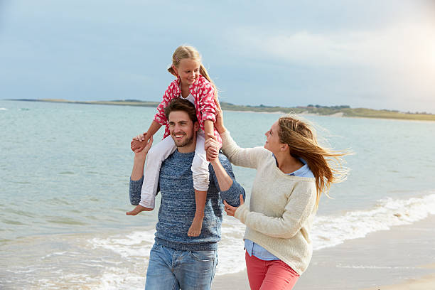 istock Family On Beach Vacation Walking By Sea 510078372