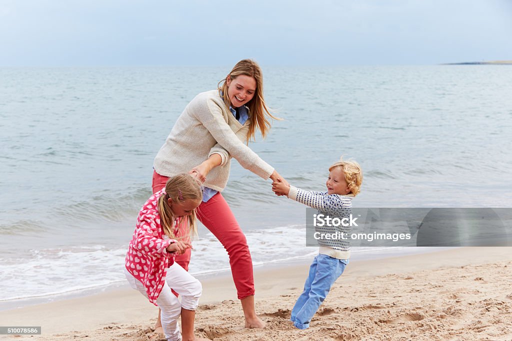 Mother And Children On Beach Vacation Playing By Sea 2-3 Years Stock Photo