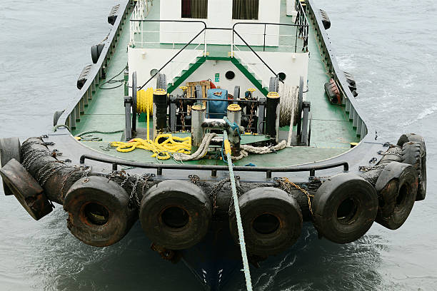 istock Tug boat attached to large ship 510079212