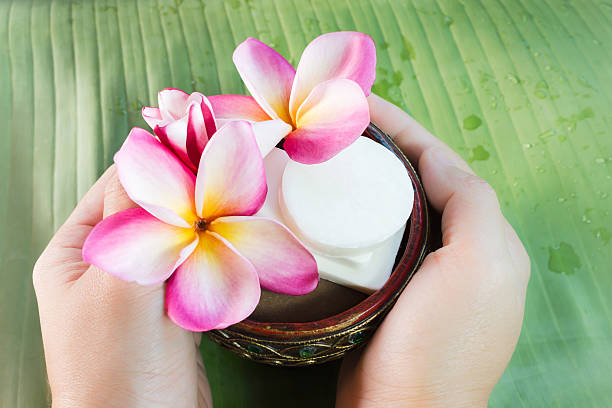istock Hand take bath soap andlowers frangipani on green banana leaf 510079718