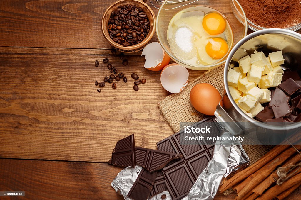 Baking chocolate cake in rural or rustic kitchen. Baking chocolate cake in rural or rustic kitchen. Dough recipe ingredients on vintage wooden table  Chocolate Stock Photo