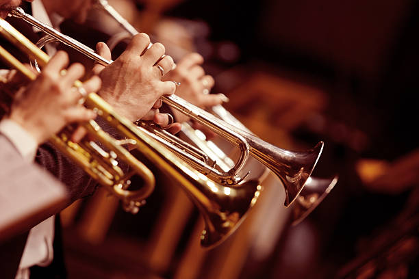 Hands trumpeters Hands trumpeters  in the orchestra closeup jazz music stock pictures, royalty-free photos & images