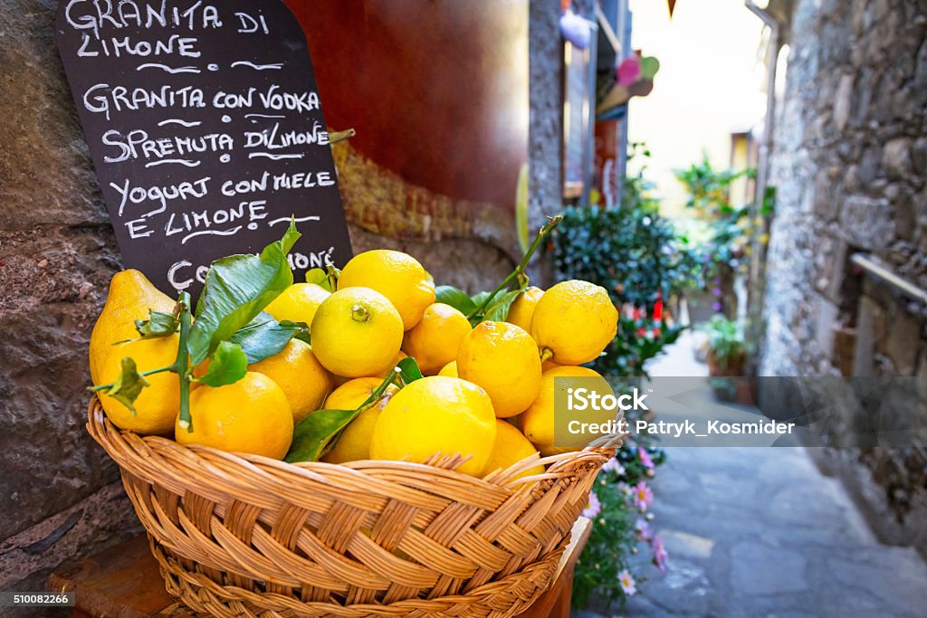 Wicker basket full of lemons on the italian street Wicker basket full of lemons on the italian street od Corniglia Sicily Stock Photo