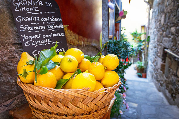 Wicker basket full of lemons on the italian street Wicker basket full of lemons on the italian street od Corniglia sicily stock pictures, royalty-free photos & images