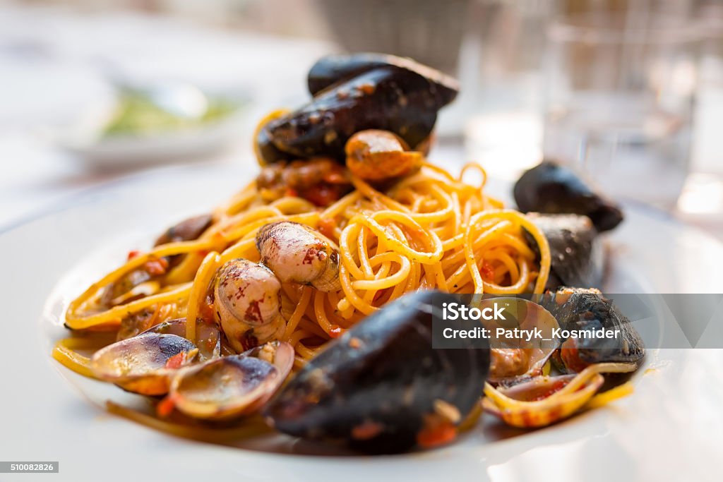 Italian pasta with seafood and herbs Italian pasta with seafood and herbs on the restaurant table Pasta Stock Photo