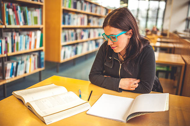 istock Young Caucasian Woman Studying in Public Library 510085592