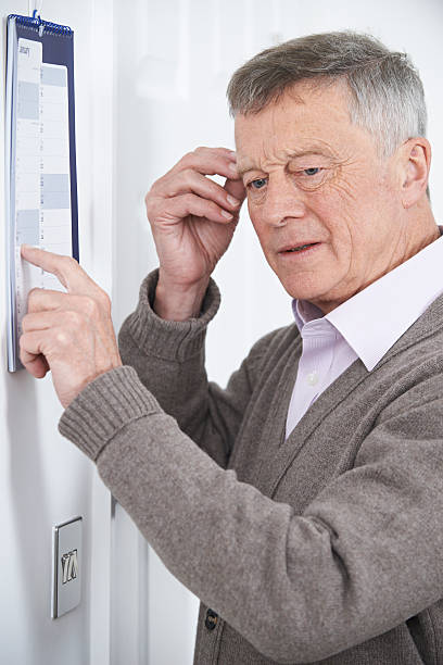 istock Confused Senior Man With Dementia Looking At Wall Calendar 510086172