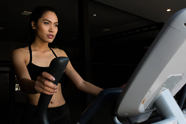 Asian women on runner machine stock photo