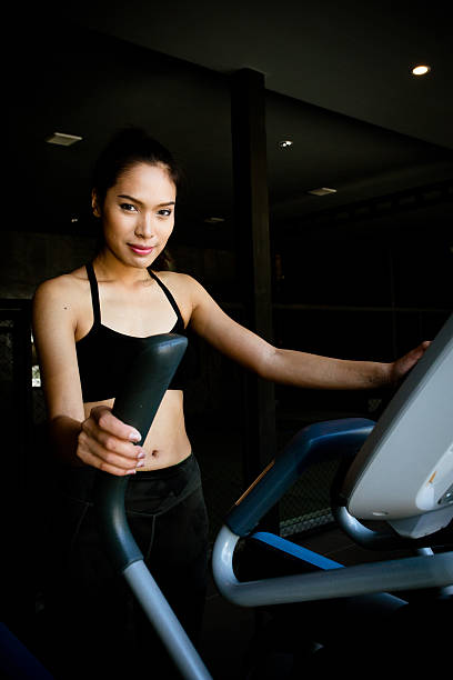 Asian women on runner machine stock photo