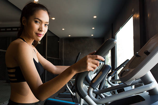 Asian women on runner machine stock photo