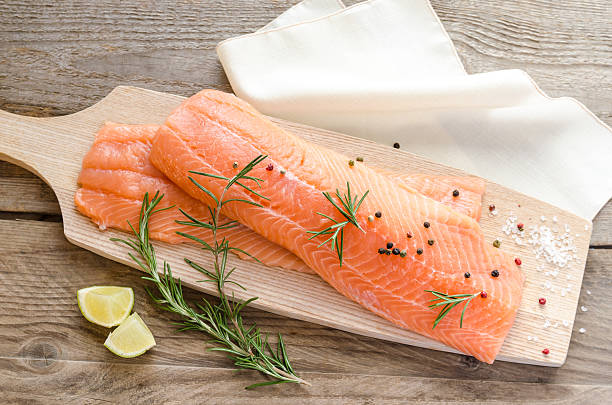 Raw salmon steaks on the wooden board Raw salmon steaks on the wooden board omega 3 and 6 stock pictures, royalty-free photos & images