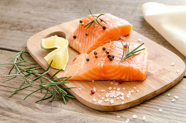 Raw salmon steaks on the wooden board Raw salmon steaks on the wooden board omega 3 and 6 stock pictures, royalty-free photos & images