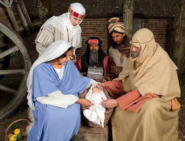 Live Christmas nativity scene reenacted in a medieval barn