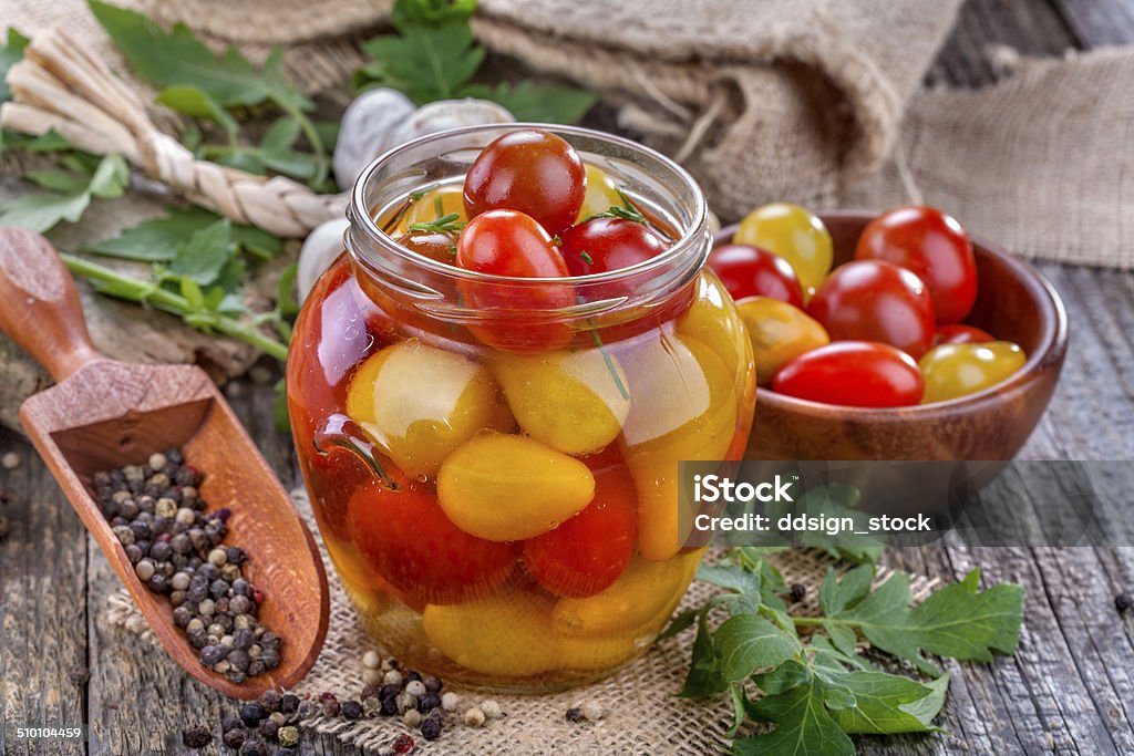 canned tomato canned and preserved domestic tomato on an old rustic table Preserves Stock Photo