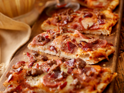 All Meat Flatbread Pizza with Pepperoni, Italian Sausage and Bacon with a Glass of Red Wine -Photographed on Hasselblad H3D2-39mb Camera