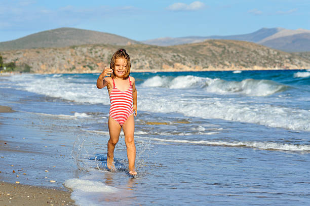 Smiling toddler girl at beach