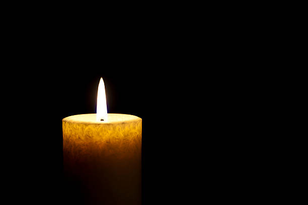 Candle Single Candle Burning in the Dark memorial vigil stock pictures, royalty-free photos & images
