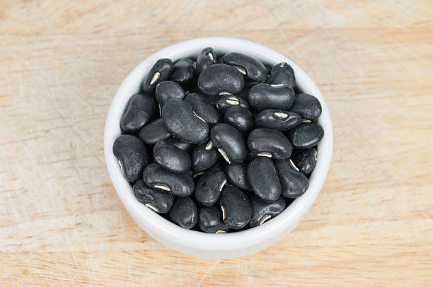 istock Black Bean in white ceramic bowl on wood background. 510126473
