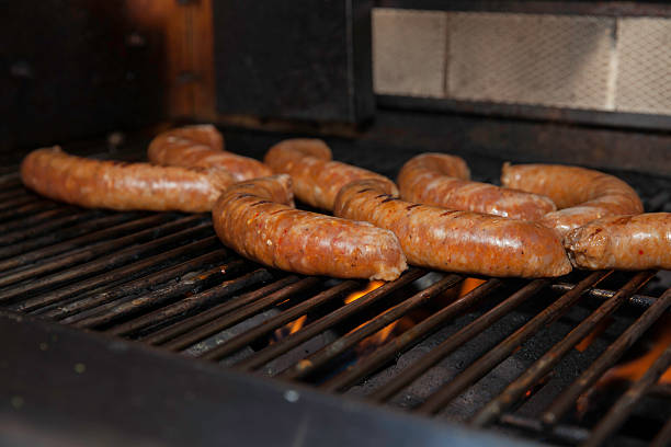istock Sausages cooking on a BBQ 510128605