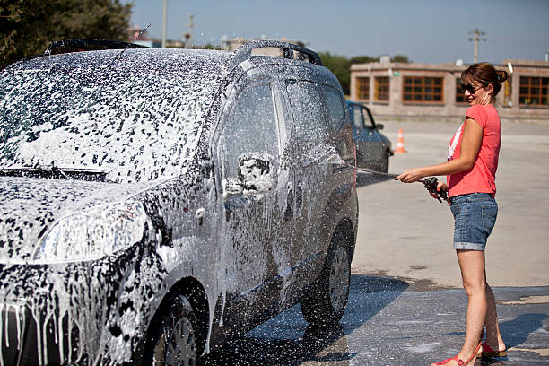 istock Girl washing a car 510129049