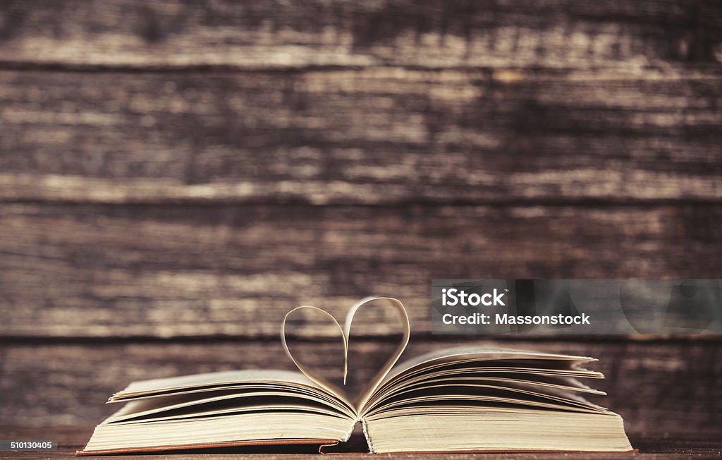 Vintage old books with heart shape on wooden table Backgrounds Stock Photo