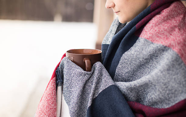 istock Girl in rug drinks hot tea, winter 510147558