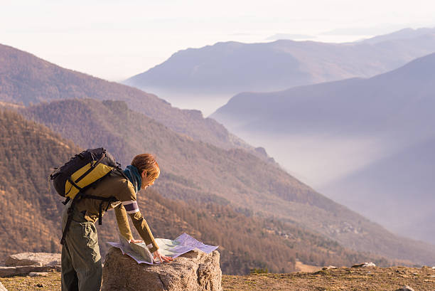istock Woman reading trekking map at panoramic spot on the Alps 510147628