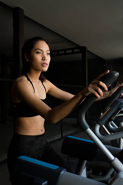Asian women on runner machine stock photo