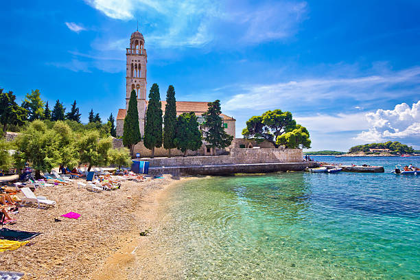 Hvar island turquoise beach and stone church, Dalmatia, Croatia