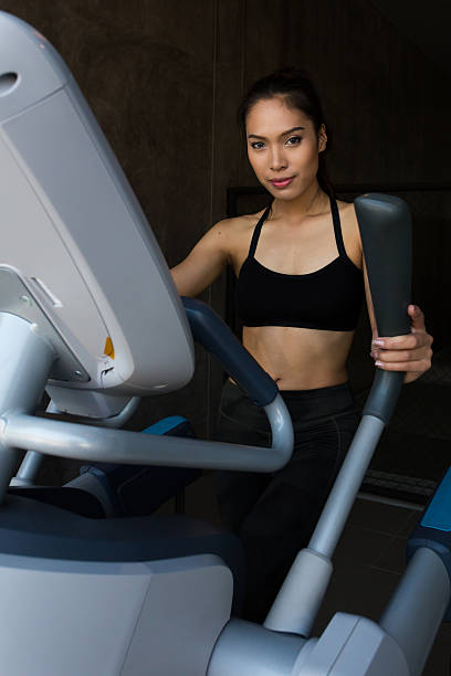 Asian women on runner machine stock photo