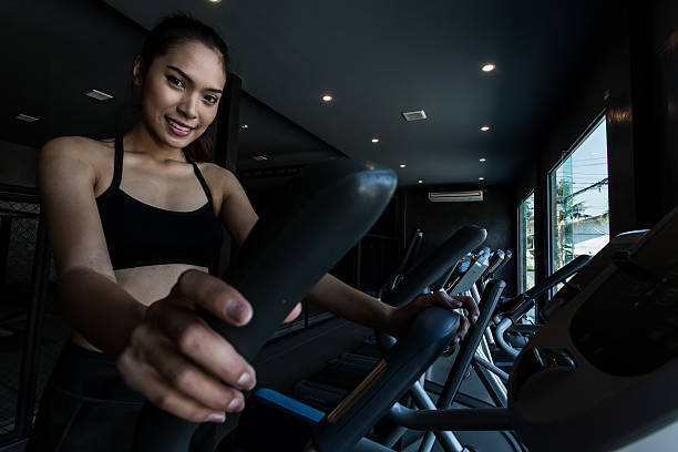 Asian women on runner machine stock photo