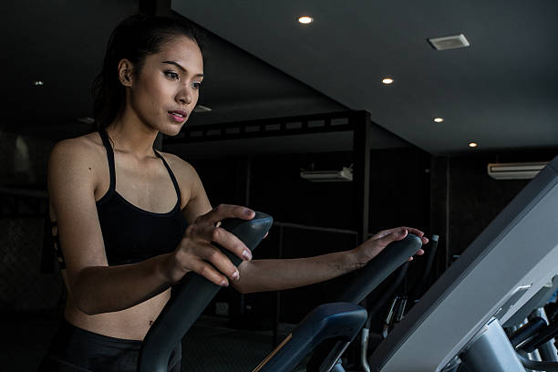 Asian women on runner machine stock photo