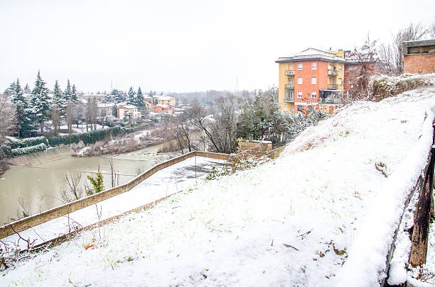 Bologna, Italy, December 28 2014 - view of the river Reno from the bike path of Casalecchio during a snowfall