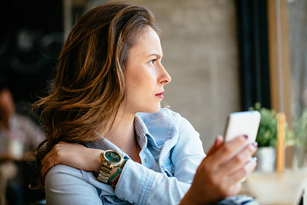 istock Philosophical looking girl holding mobile 510149028