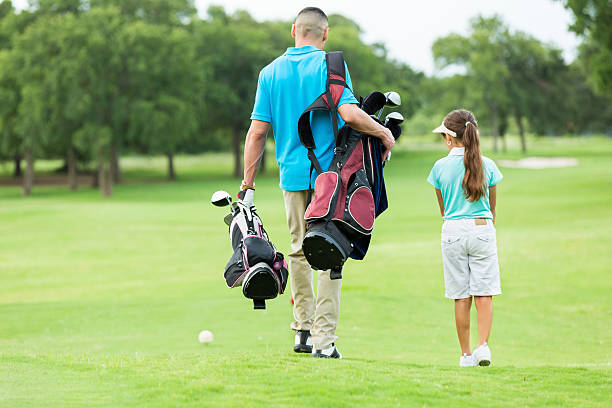 istock Father and daughter walk on golf course 510149432