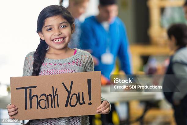 Pretty Hispanic Girl Holds Thank You Sign In Soup Kitchen Stock Photo - Download Image Now