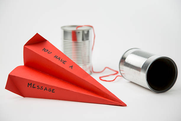 paper plane and cans for a simple communication stock photo