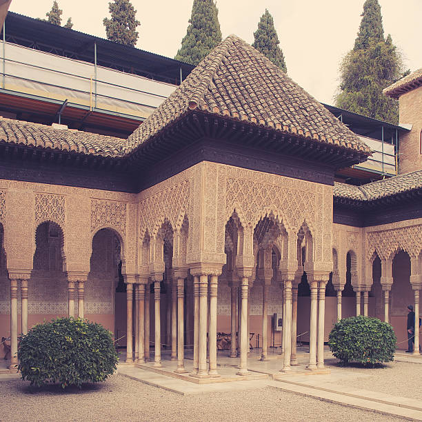 Courtyard of the Lions (El Patio de los Leones) in the Alhambra a moorish mosque, palace and fortress complex in Granada, Spain. Photo in retro style.