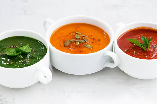 istock assortment of colorful vegetable cream soup on a white table 510155142
