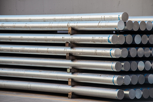Large group of aluminum cylinders in warehouse taken in daylight.