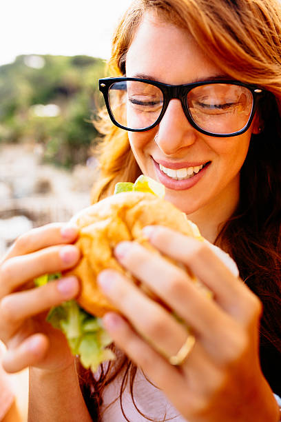 istock Girl Eating Hamburger 510155495